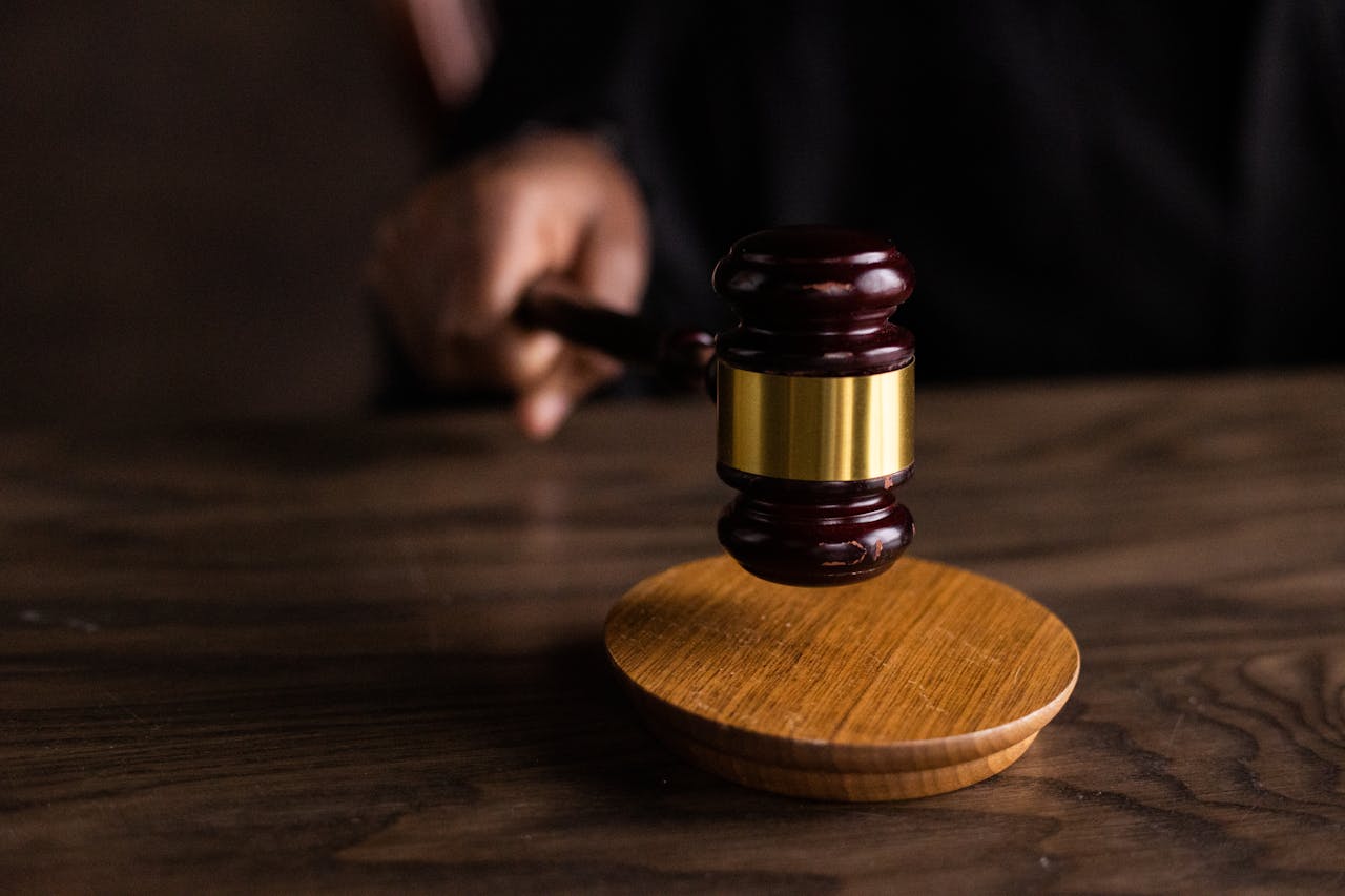 heros-img A gavel striking a sound block, symbolizing justice and legal authority in a courtroom setting.